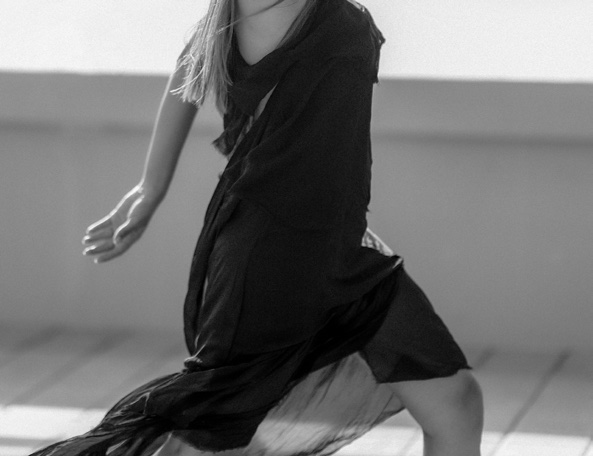 Black and white photograph of a dancer in flowing fabric